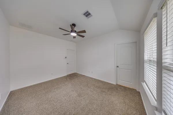 a view of a room with a fan & a window