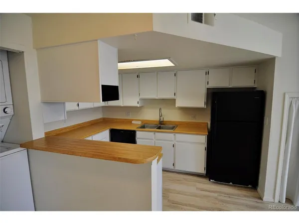 a kitchen with a refrigerator and a sink