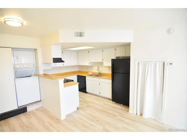 a kitchen with a cabinets a sink and a stove