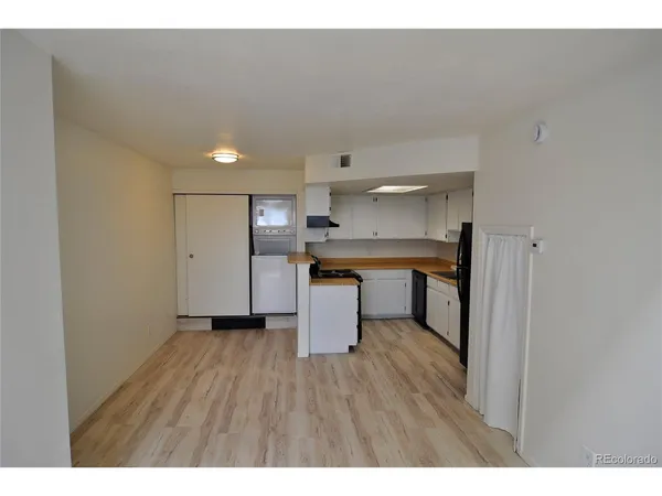 a kitchen with a refrigerator and a sink