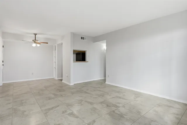 a view of a kitchen with a sink and a chandelier fan