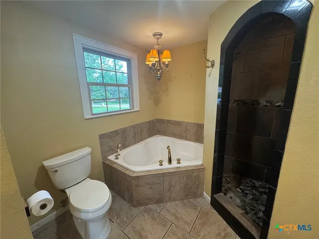 a white bath tub sitting next to a toilet