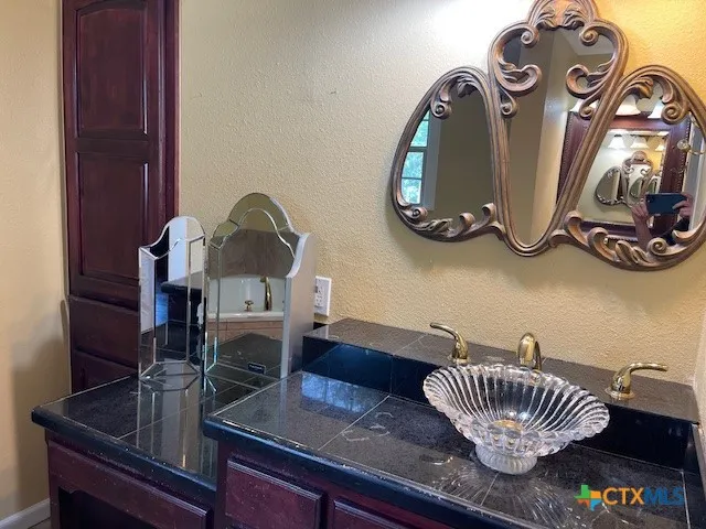 a living room with furniture and a mirror