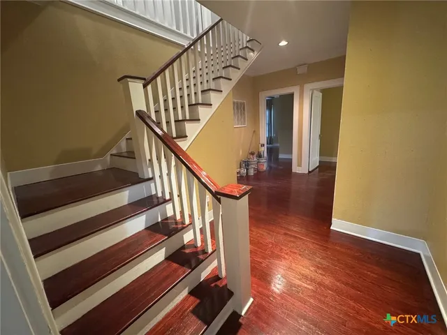 a view of entryway and hall with wooden floor