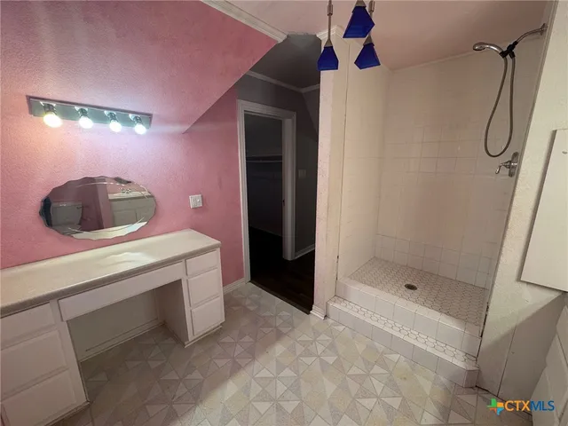 a bathroom with a sink and shower