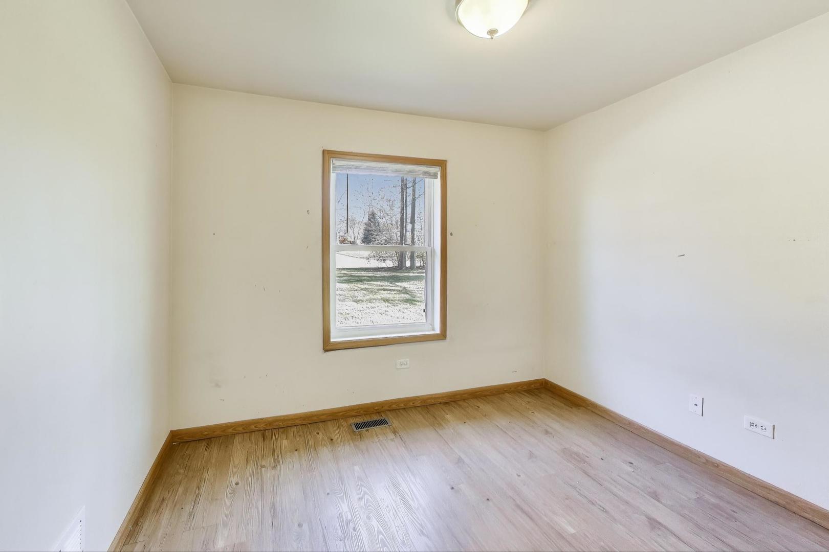 35944 North Wilson Road Ingleside, IL 60041 - Photo 11 of 26 an empty room with wooden floor and windows