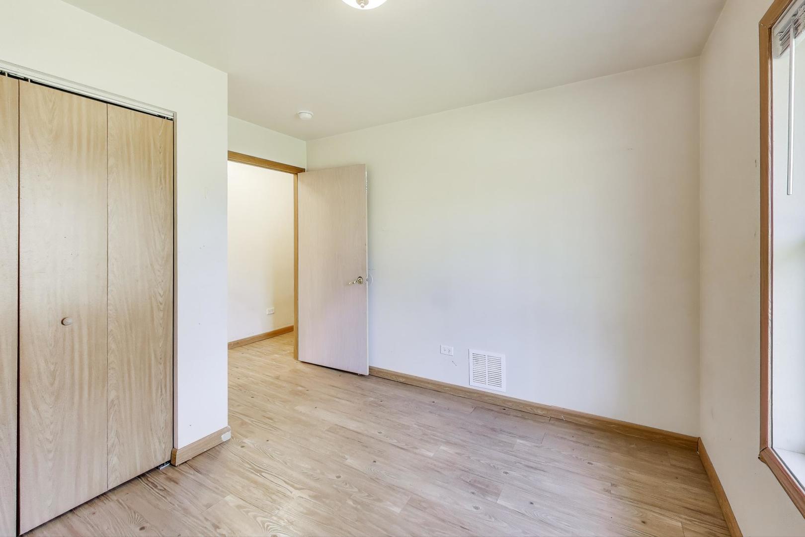 35944 North Wilson Road Ingleside, IL 60041 - Photo 12 of 26 an empty room with wooden floor and door