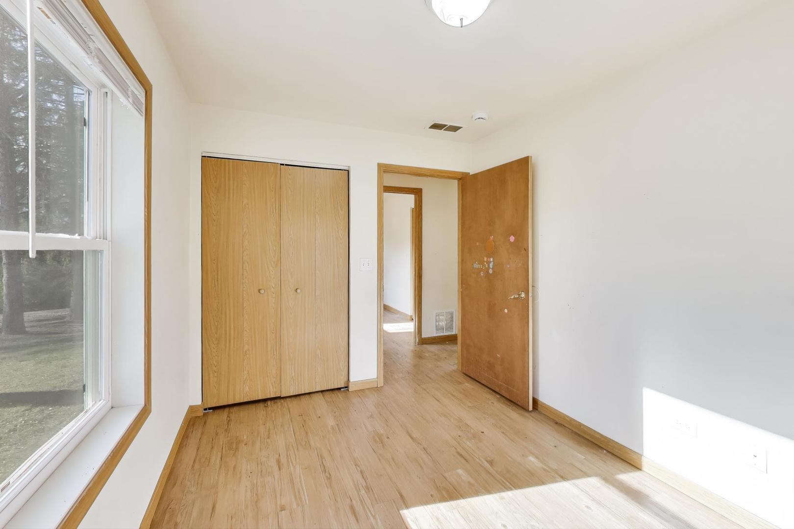 35944 North Wilson Road Ingleside, IL 60041 - Photo 14 of 26 a view of an empty room with wooden floor and a window