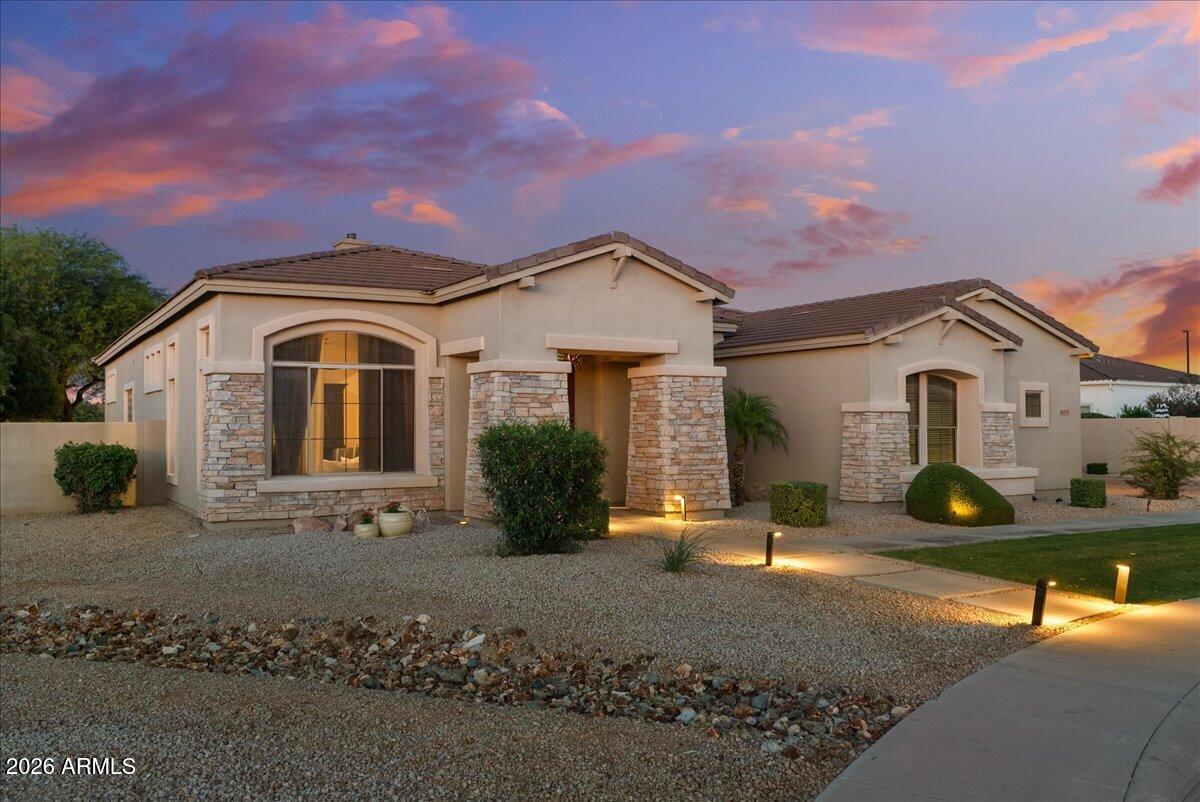 6427 South Magic Court Gilbert, AZ 85298 - Photo 61 of 71 a front view of a house with a garden