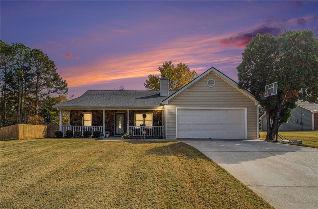 a front view of house with yard and trees around