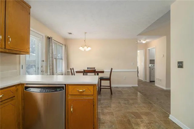 a kitchen with kitchen island a counter top space a sink and cabinets