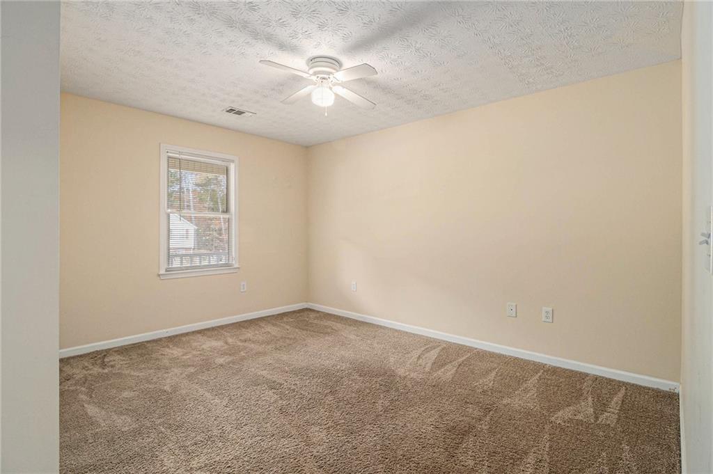 40 Willow Tree Terrace Covington, GA 30016 - Photo 19 of 32 an empty room with windows and fan
