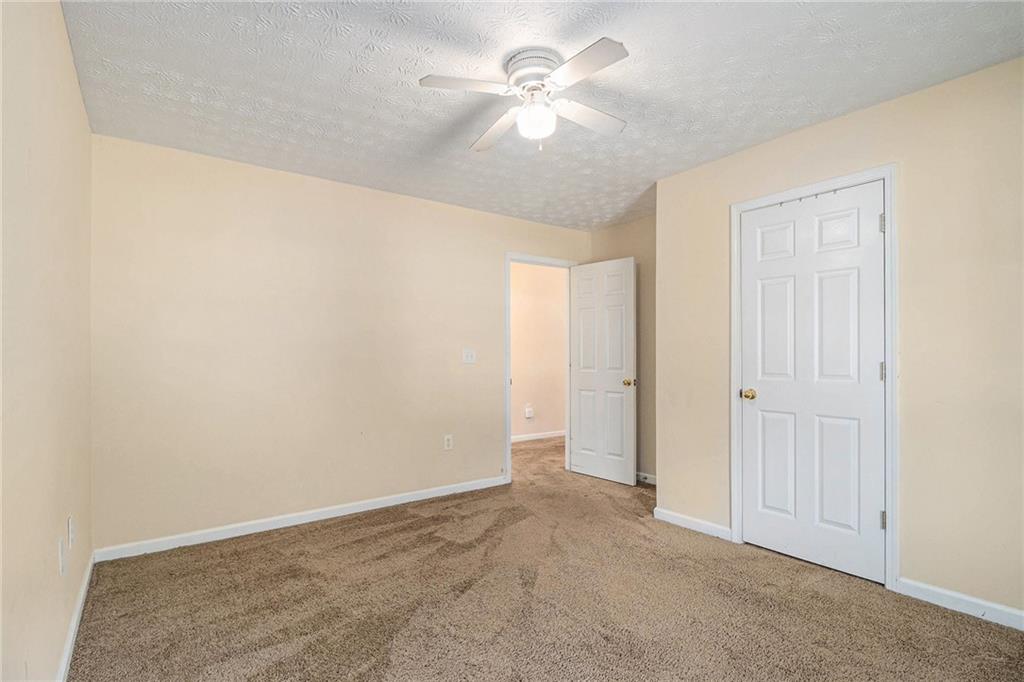 40 Willow Tree Terrace Covington, GA 30016 - Photo 20 of 32 an empty room with a ceiling fan and a window