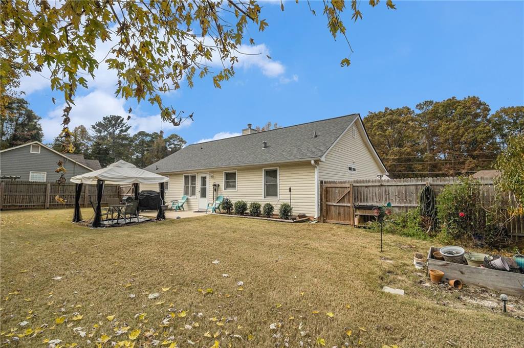 40 Willow Tree Terrace Covington, GA 30016 - Photo 29 of 32 a view of a house with a big yard and large trees