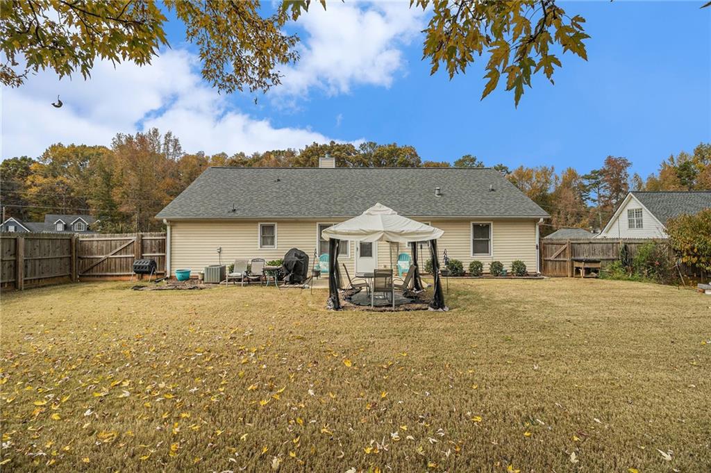 40 Willow Tree Terrace Covington, GA 30016 - Photo 30 of 32 a view of a house with a big yard and large trees