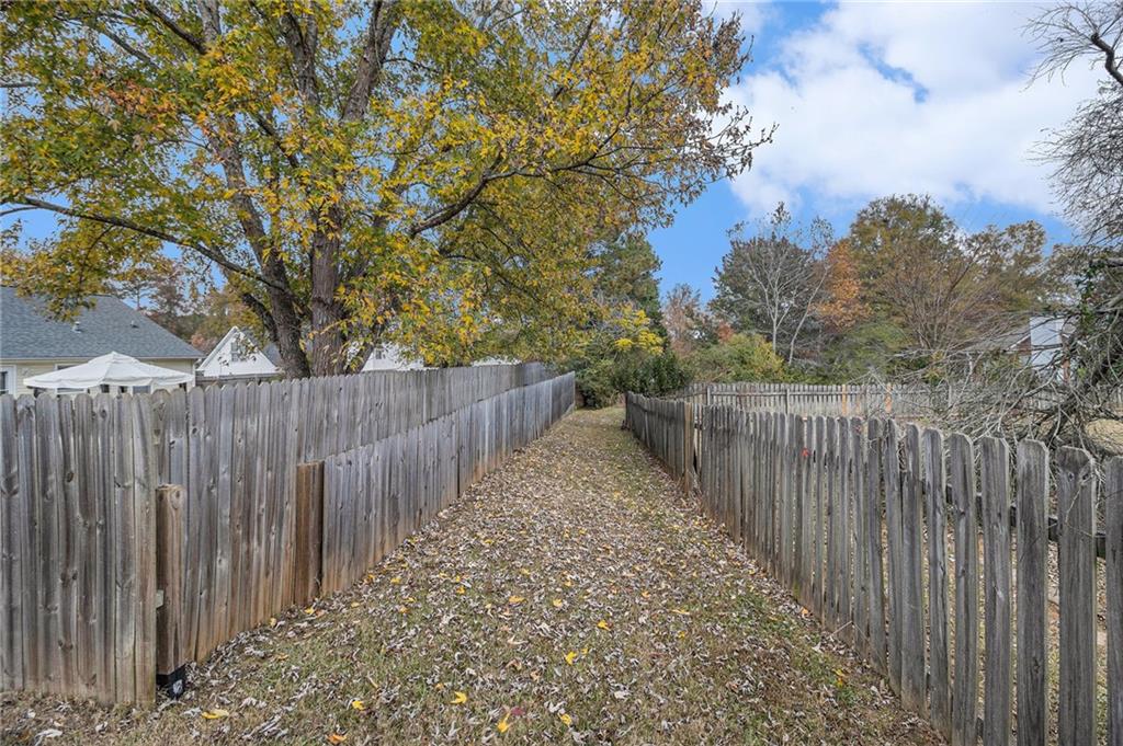 40 Willow Tree Terrace Covington, GA 30016 - Photo 31 of 32 a view of a pathway with a wrought fence