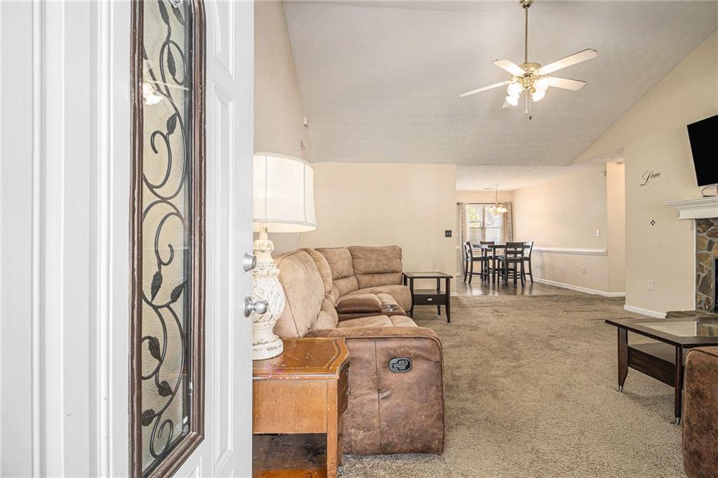 40 Willow Tree Terrace Covington, GA 30016 - Photo 5 of 32 a living room with furniture and a chandelier