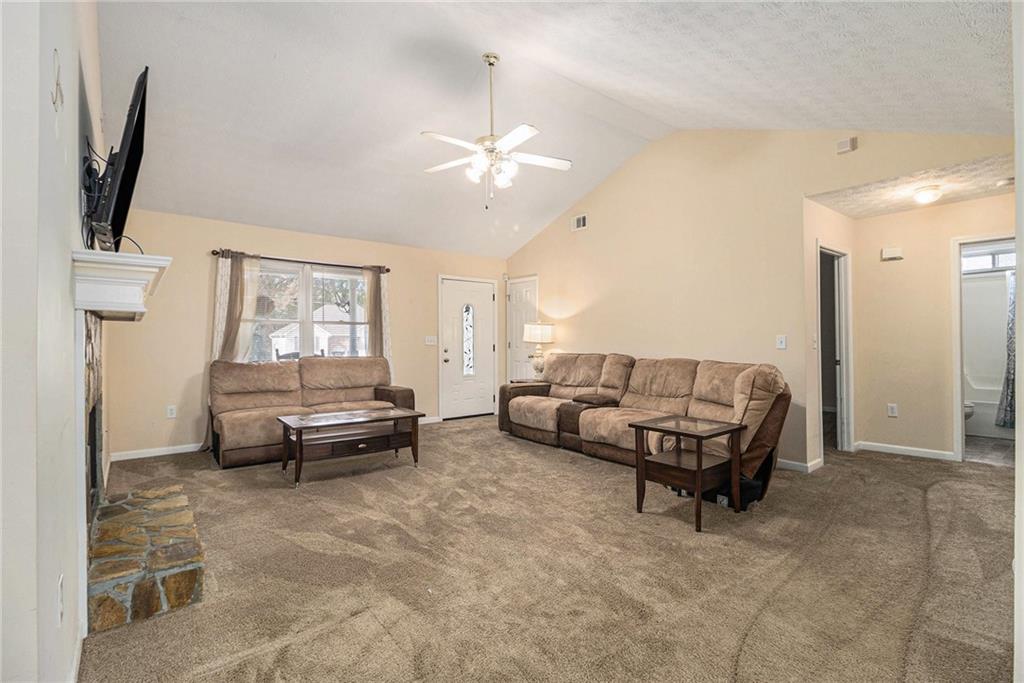 40 Willow Tree Terrace Covington, GA 30016 - Photo 6 of 32 a living room with furniture and a flat screen tv