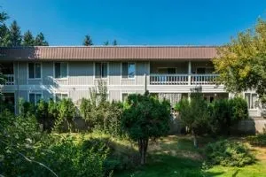 a view of house with yard and outdoor seating