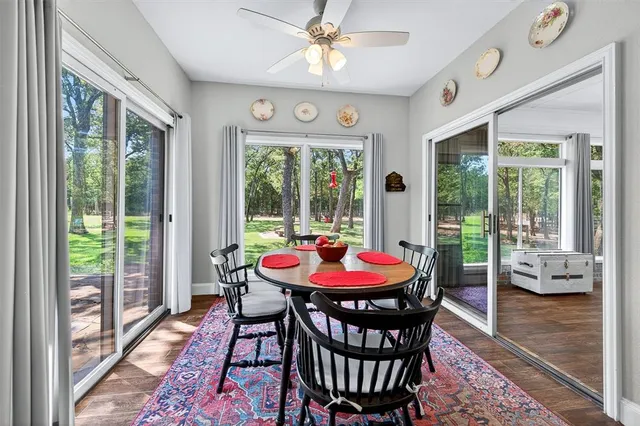 a dining room with furniture a rug and a large window