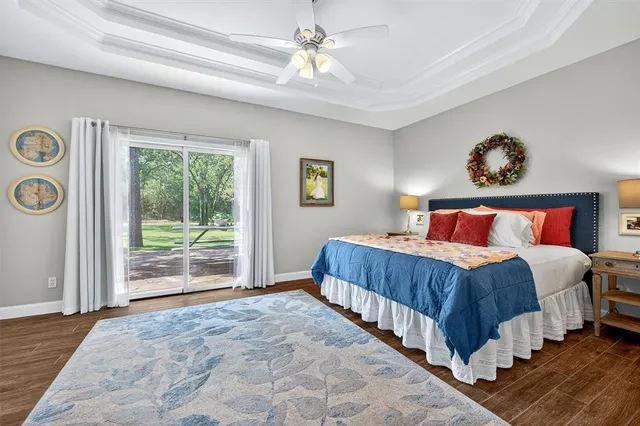 a bedroom with a large bed and a chandelier