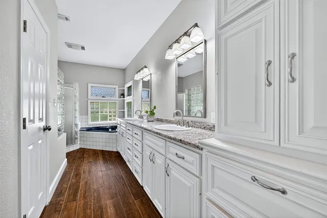 a large white kitchen with a large window