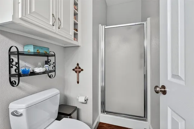 a bathroom with a toilet and a shower