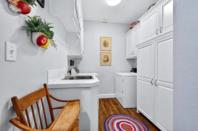 a bathroom with a sink a window and stainless steel appliances