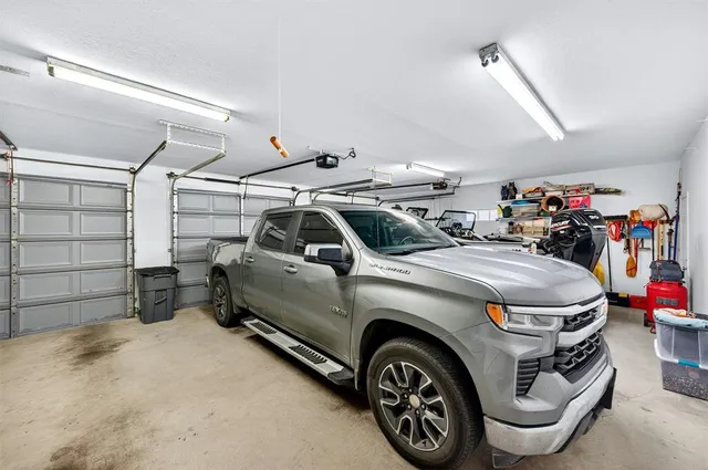 a bathroom with a granite countertop sink a mirror and a shower