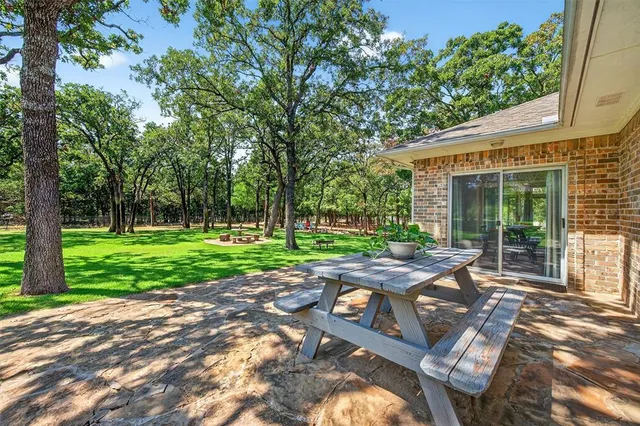 a view of a backyard with sitting area
