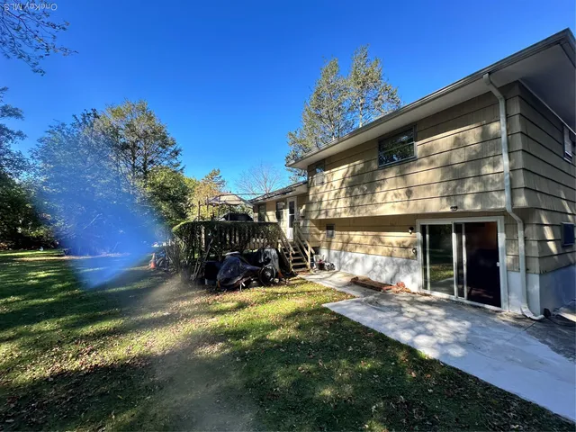 a view of a house with backyard porch and sitting area