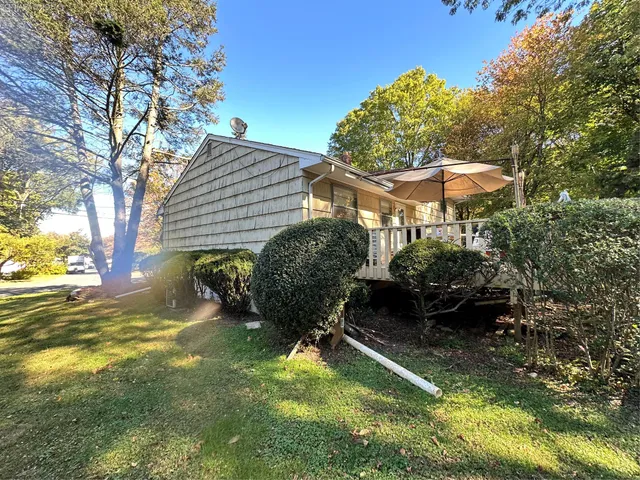 a backyard of a house with yard and outdoor seating