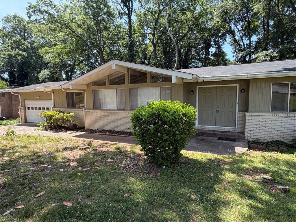 4707 Riverwood Circle Decatur, GA 30035 - Photo 2 of 17 a front view of a house with a yard and porch