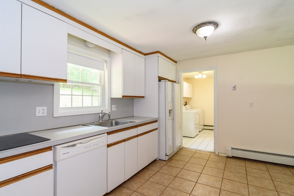 33 Eisenhower Road Framingham, MA 01701 - Photo 10 of 20 a kitchen with a sink cabinets and window
