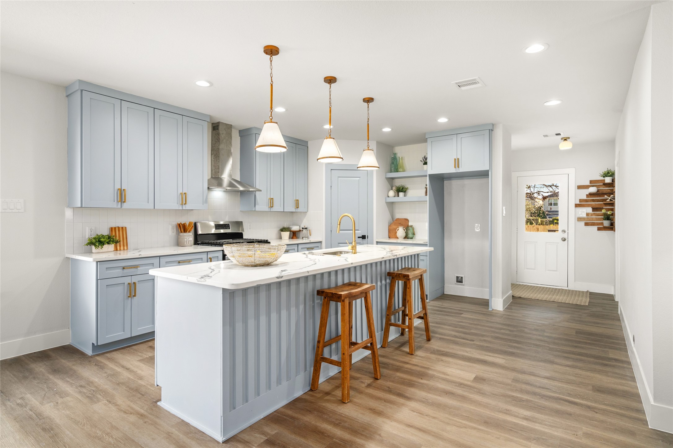 5420 Pease Street Houston, TX 77023 - Photo 18 of 43 a kitchen with stainless steel appliances kitchen island a hardwood floor and a sink