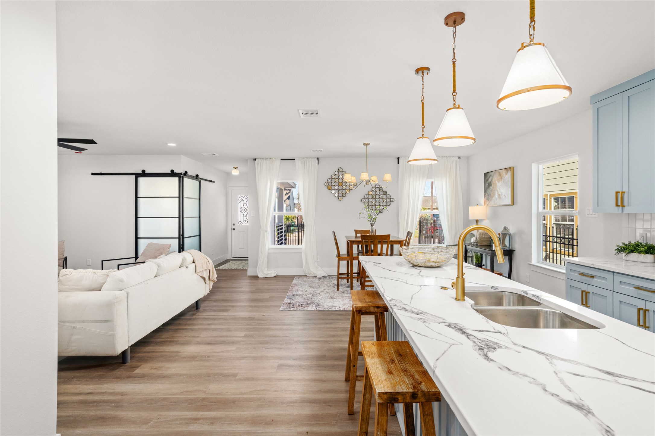 5420 Pease Street Houston, TX 77023 - Photo 20 of 43 a large room with lots of white furniture and wooden floor