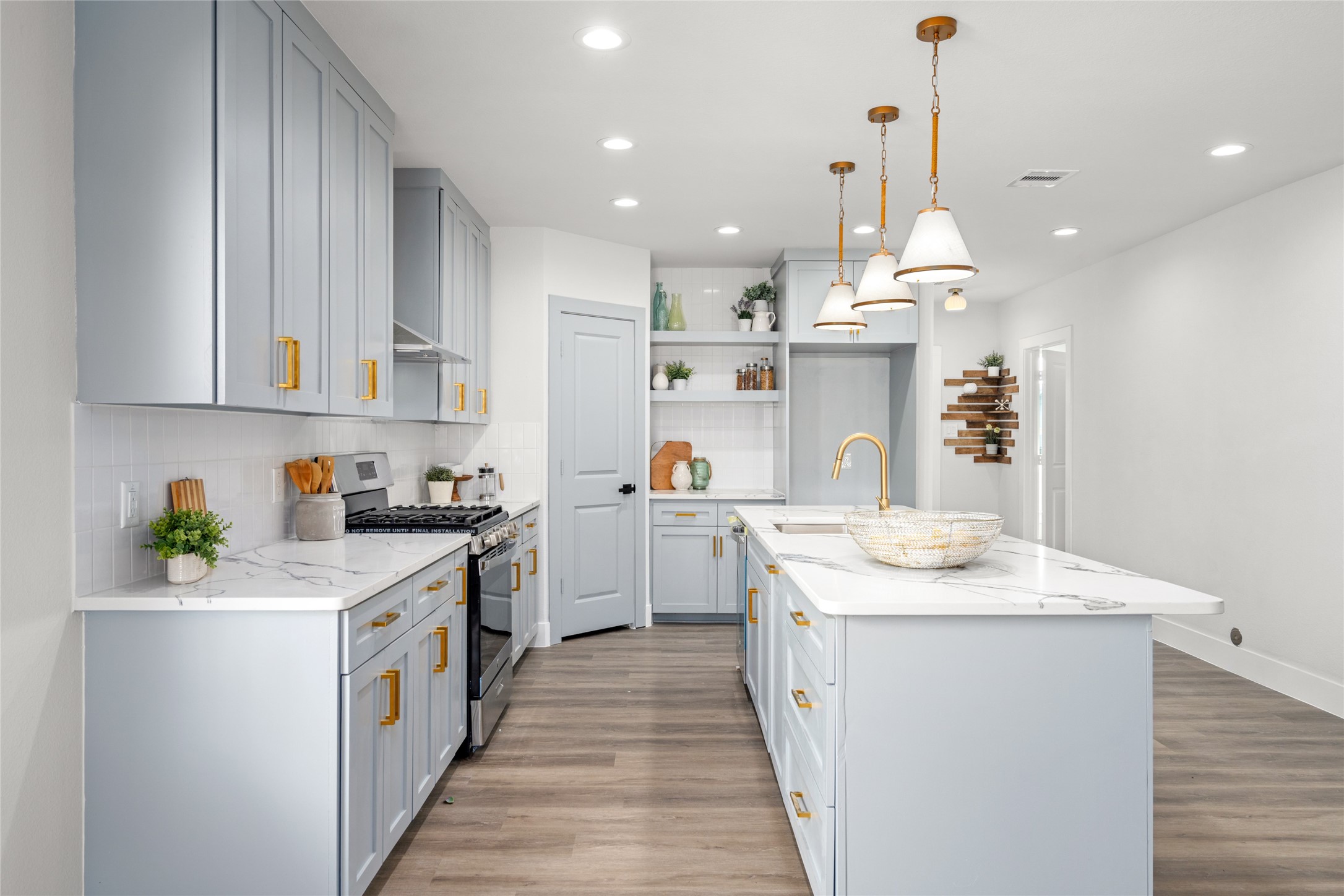 5420 Pease Street Houston, TX 77023 - Photo 25 of 43 a kitchen with kitchen island a sink stainless steel appliances and cabinets