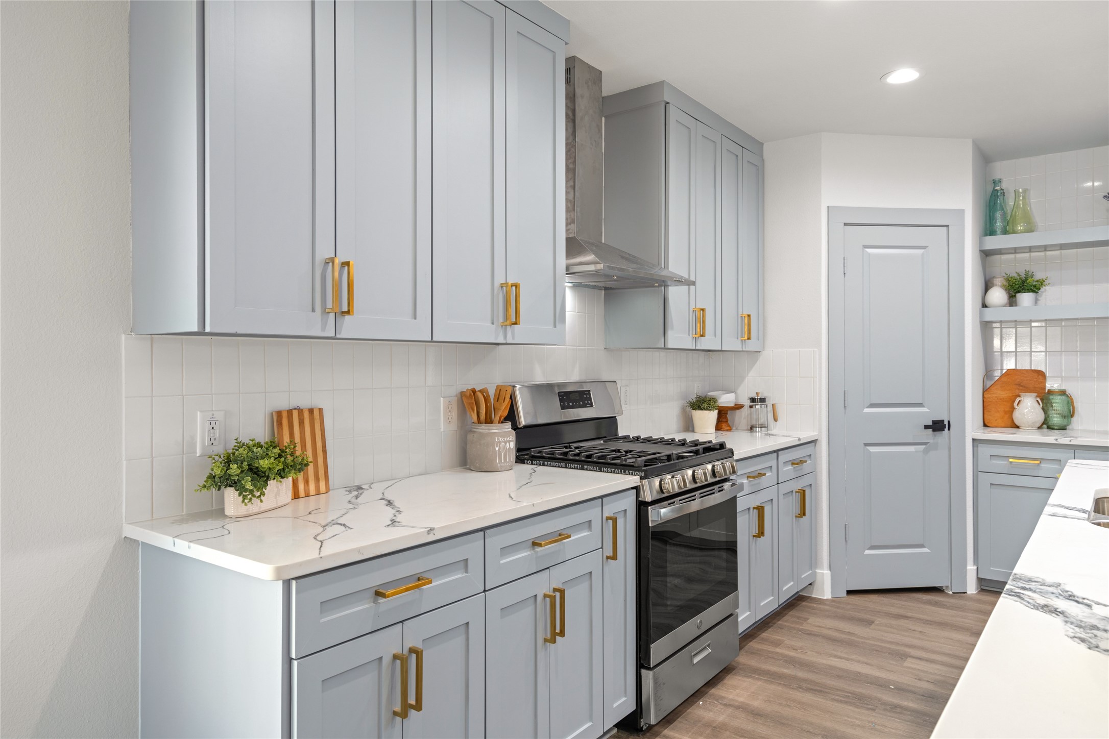 5420 Pease Street Houston, TX 77023 - Photo 26 of 43 a kitchen with stainless steel appliances granite countertop a stove and a white cabinets