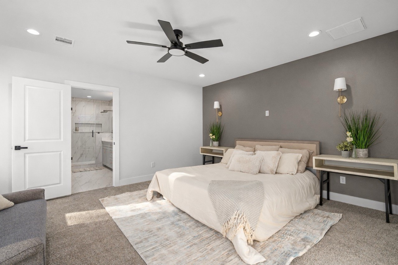 5420 Pease Street Houston, TX 77023 - Photo 29 of 43 a bedroom with a large bed and a chandelier