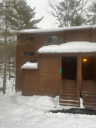 a view of house with a tree