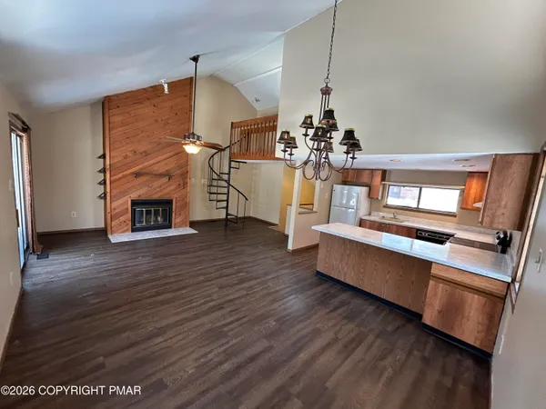 a kitchen with wooden floors and wooden cabinets