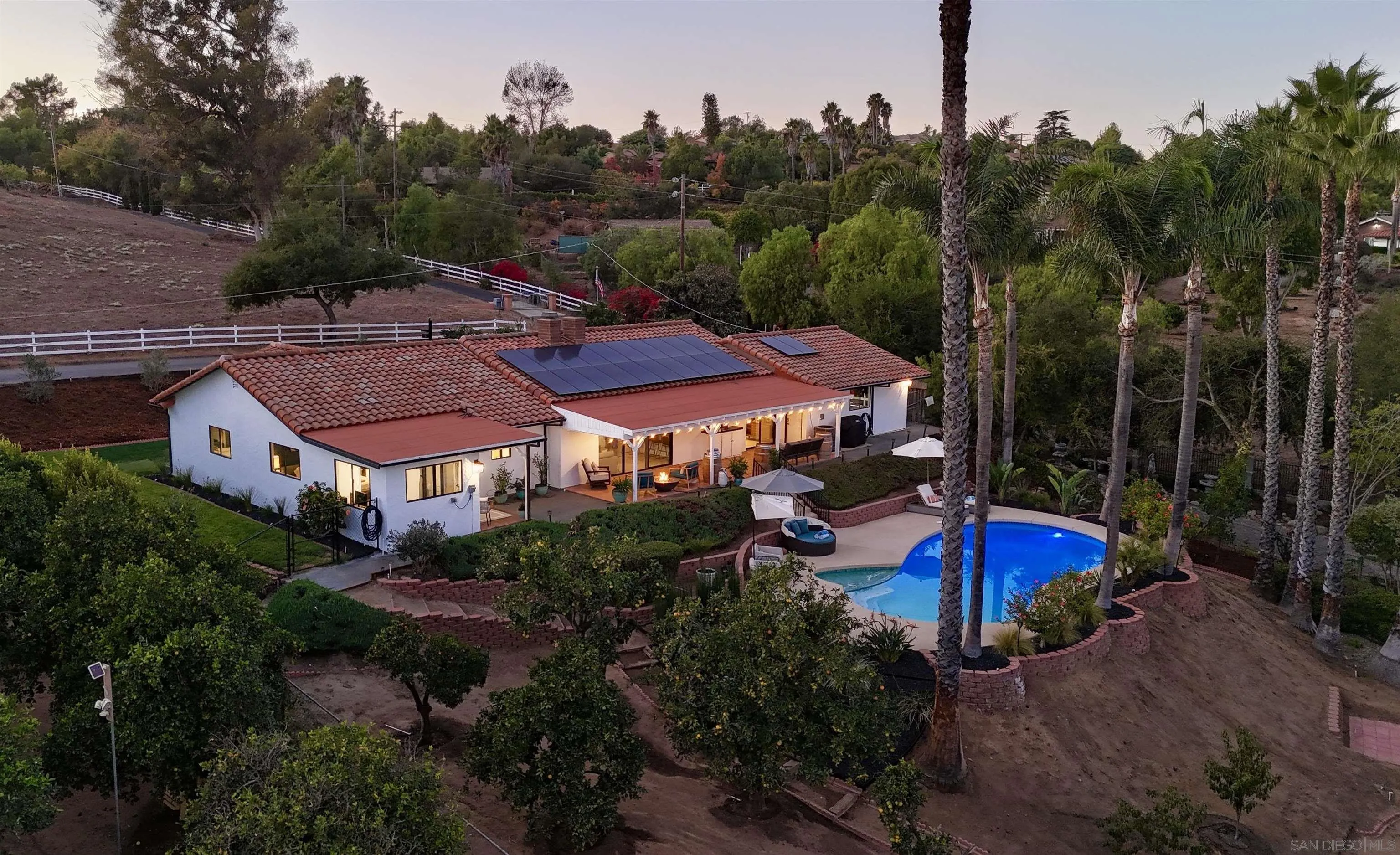 an aerial view of a house with yard swimming pool and outdoor seating