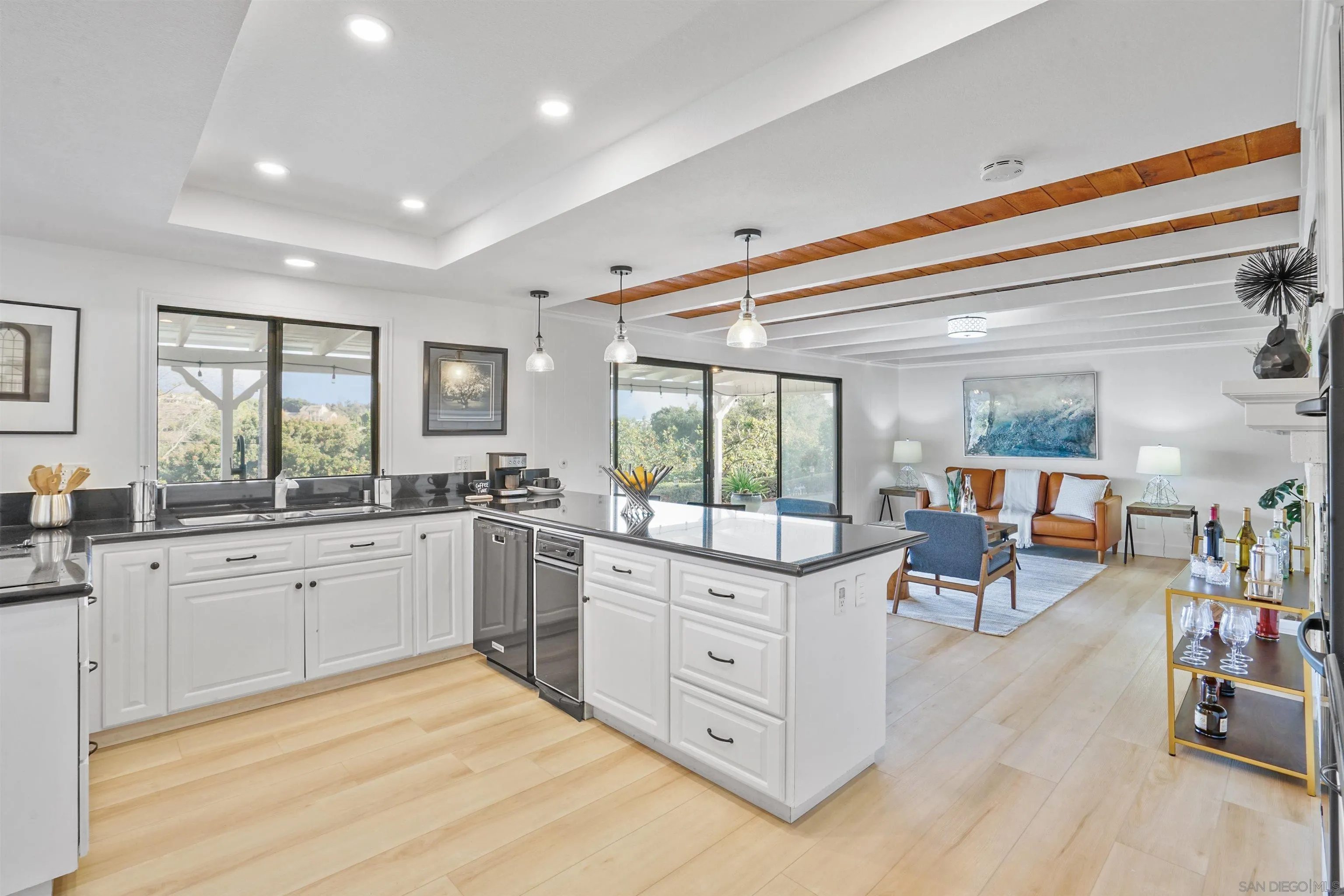 174 Vía De Casa Fallbrook, CA 92028 - Photo 13 of 47 a large white kitchen with cabinets a sink a window and chairs