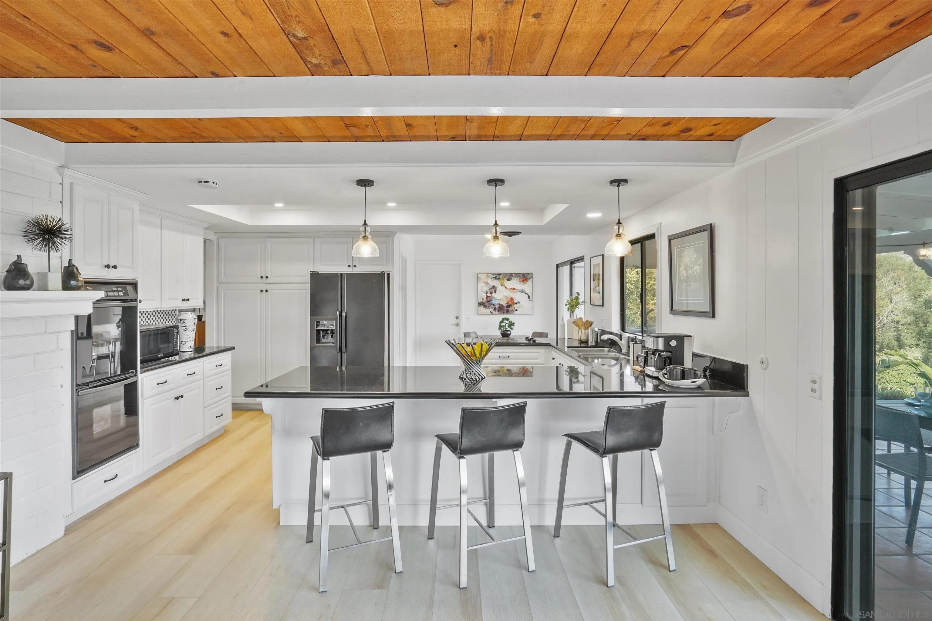 174 Vía De Casa Fallbrook, CA 92028 - Photo 15 of 47 a kitchen with stainless steel appliances kitchen island granite countertop a refrigerator and microwave