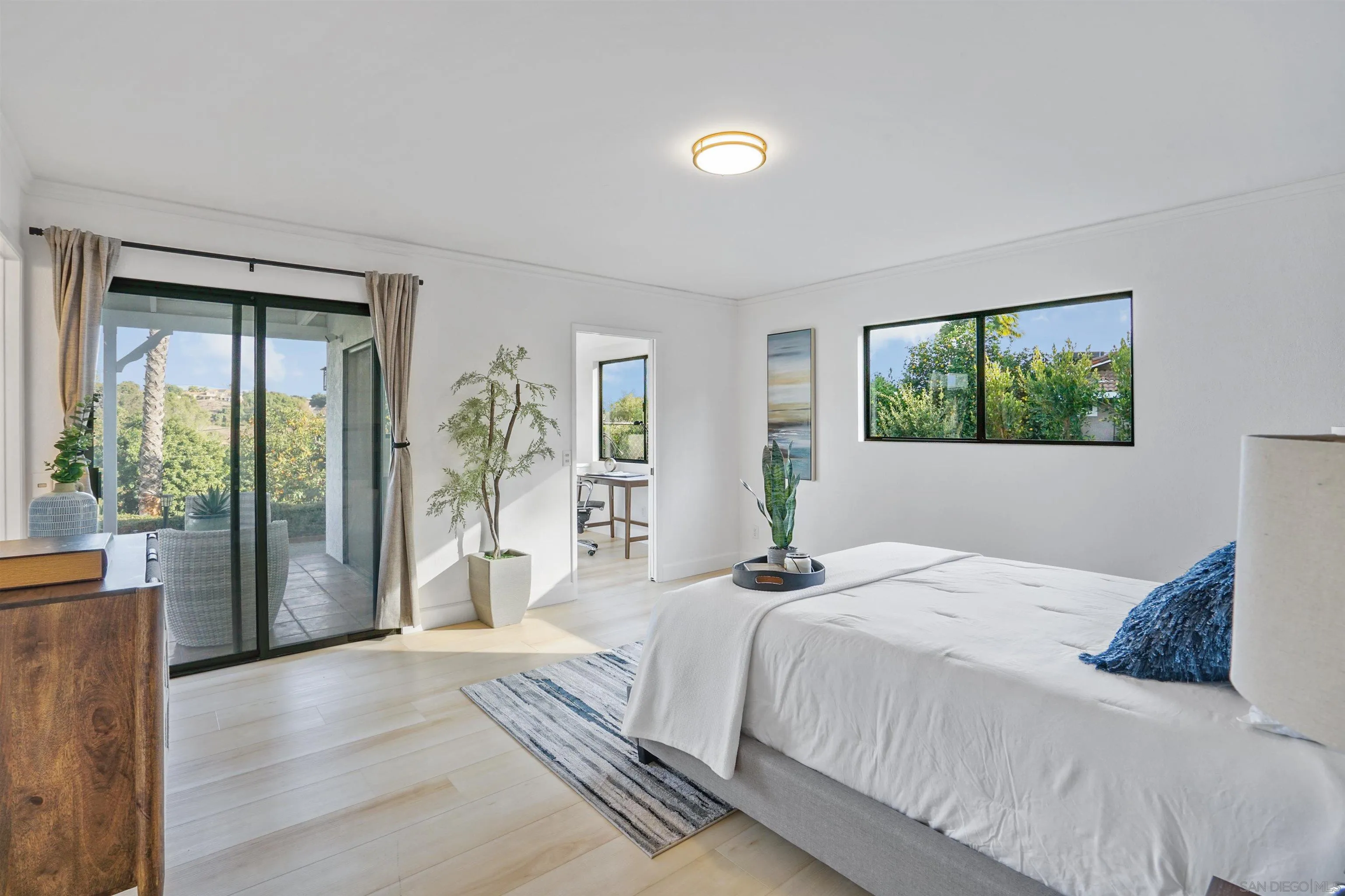 174 Vía De Casa Fallbrook, CA 92028 - Photo 24 of 47 a bedroom with a large bed and a large window