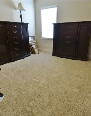 a bed room with a bed and dresser