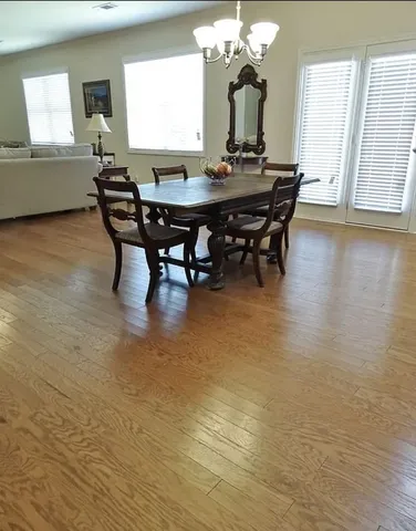 a view of a dining room with furniture and a chandelier
