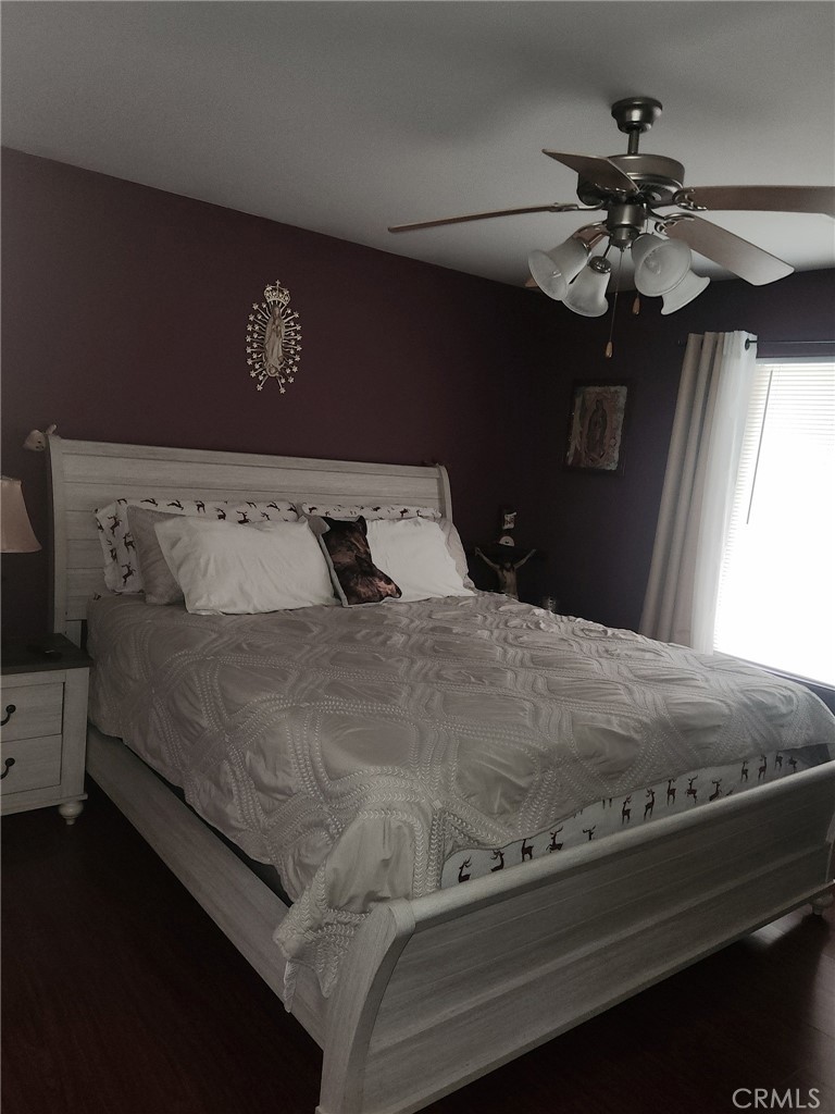 5348 Gatson Street Bakersfield, CA 93314 - Photo 13 of 33 a bedroom with a bed and a chandelier
