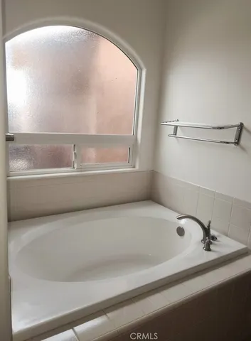 a bath tub sitting next to a window