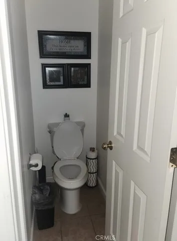 a white toilet sitting in a bathroom next to a sink